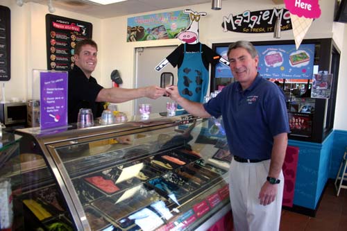 Jacob Rice, promotions manager for Maggie Moo's Ice Cream in Norman, hands Uwe von Schamann, J. D. McCarty Center director of development, a sample spoon of ice cream