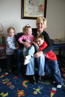 Susan Linn from Prague, Oklahoma, sits with her adopted children in the waiting room at the J. D. McCarty Center