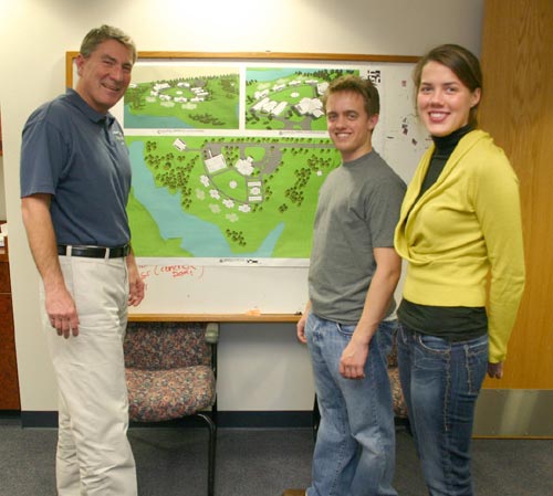 Uwe von Schamann (left), director of development for the J. D. McCarty Center, shows plans for the layout of Camp ClapHans to Heath Thompson and Amy Herritt