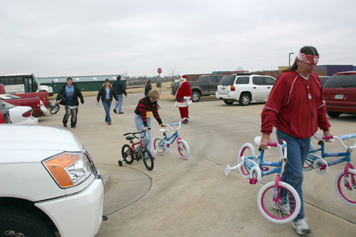 President of the OU Hourly Employee Council, Linda Smith (center) and members of the council delivered 20 bicycles and tricycles plus helmets, knee and elbow pads to the J. D. McCarty Center in Norman as a part of the council's annual Christmas project.