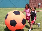 Two Kids Playing with a VERY Large Ball